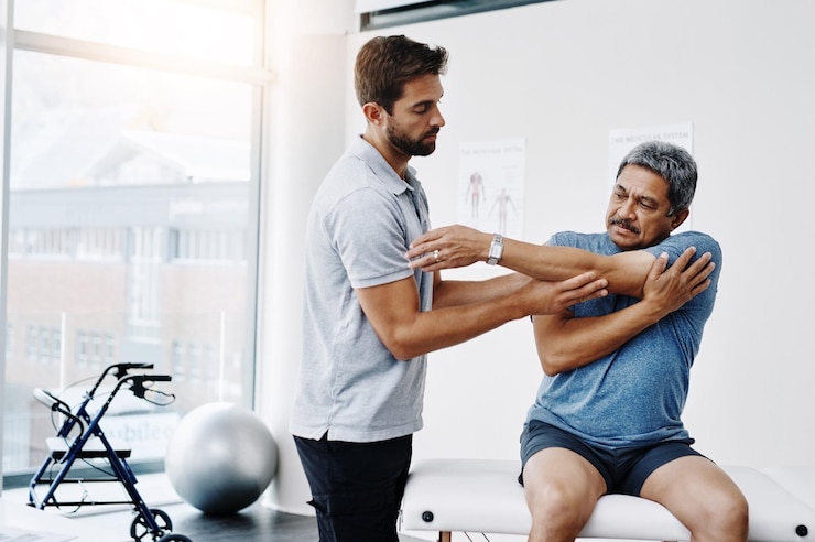 Photo healthcare stretching and mature man in clinic helping and physiotherapist for exercise and fitness hospital workout and physiotherapy of patient rehabilitation and concentration of person