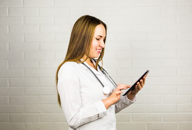 Healthcare, technology and medicine concept - smiling female doctor with tablet pc computer