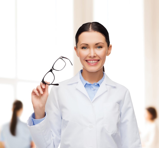 healthcare, vision and medicine concept - smiling female doctor with eyeglasses