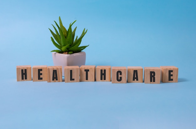 Healthcare word concept on wooden cubes on blue.