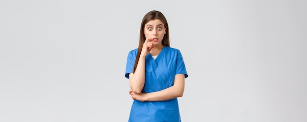 Healthcare workers prevent virus insurance and medicine concept intrigued female doctor or nurse in