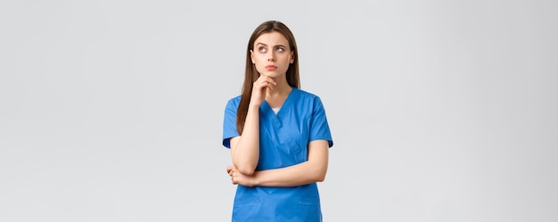 Healthcare workers prevent virus insurance and medicine concept thoughtful concerned female nurse or