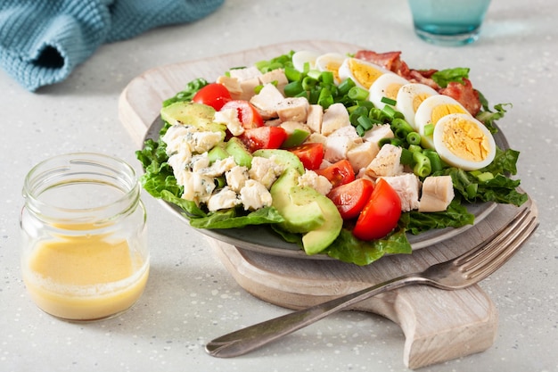 Healthy american cobb salad with egg bacon avocado chicken tomato hearty keto low carb diet