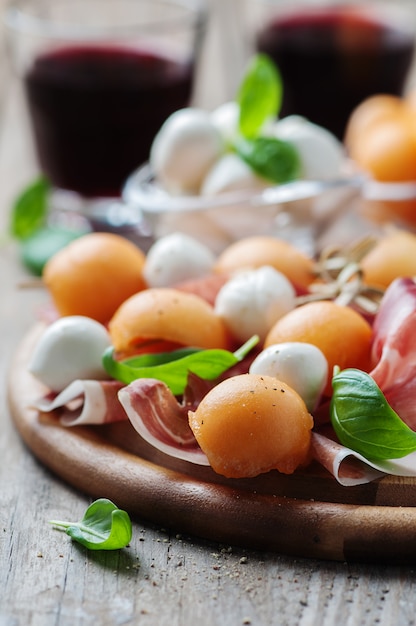 Healthy appetizer with melon, ham and mozzarella