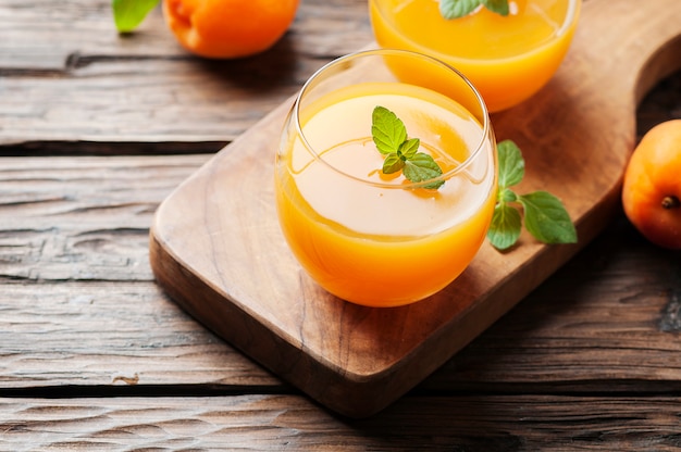 Healthy apricot juice with mint on the wooden table