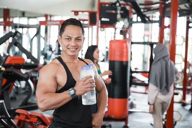 Healthy asian muscular man with drink