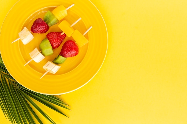 Healthy assorted fruit skewers from above