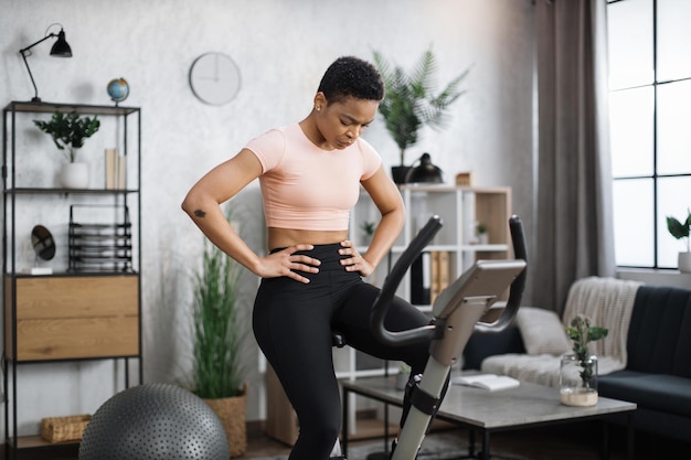 Healthy athletic female doing cardio on stationary bike