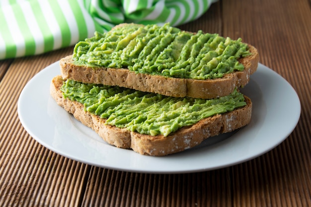 Healthy avocado sandwich, toast bread. Mushed avocado pasta. Guacamole.