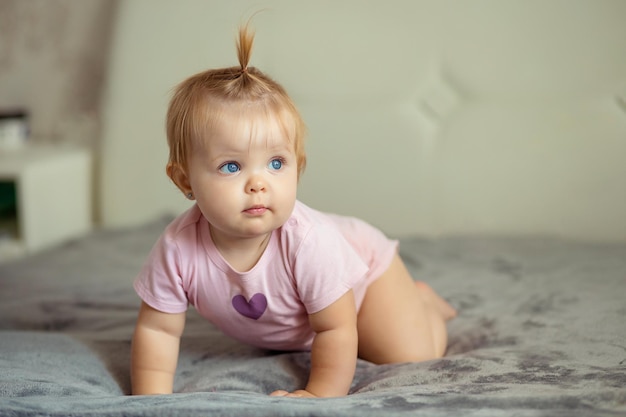 healthy baby playing and smiling in a crib