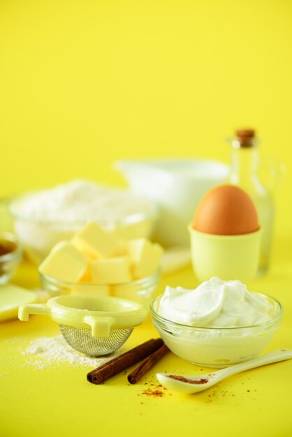 Healthy baking ingredients - butter, sugar, flour, eggs, oil, spoon, rolling pin milk. Bakery food frame, cooking concept.