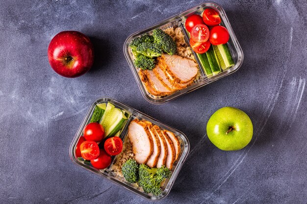 Healthy balanced lunch box with chicken, rice, vegetables.