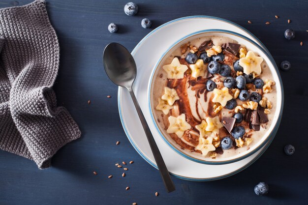 Healthy banana smoothie bowl with blueberry chocolate walnuts