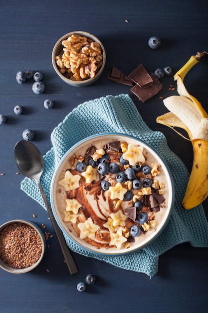 Healthy banana smoothie bowl with blueberry chocolate walnuts