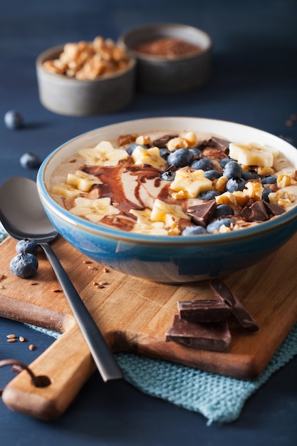 Healthy banana smoothie bowl with blueberry chocolate walnuts