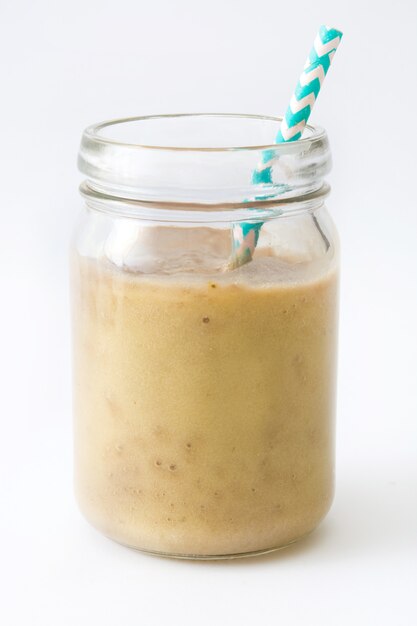 Photo healthy banana smoothie in glass isolated