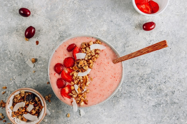 Healthy banana and strawberries smoothie in a bowl