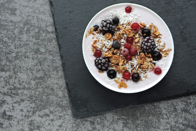 Healthy beautiful breakfast bowl with yogurt, granola and berries.