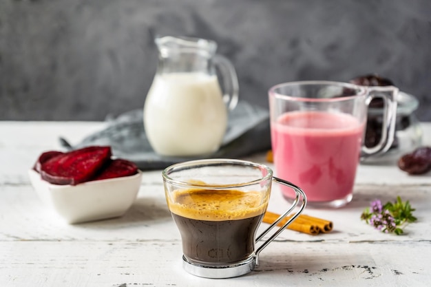 Healthy beetroot latte and espresso with basic ingredients for cooking