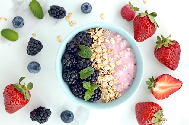 Healthy berry oatmeal in a blue bowl