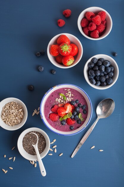 Healthy berry smoothie bowl with strawberry blueberry raspberry and chia seed