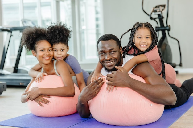 Healthy black family children and parent exercise activity healthcare together at fitness sport club