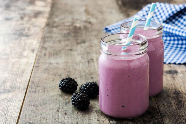 Healthy blackberry smoothie in glass on wooden table