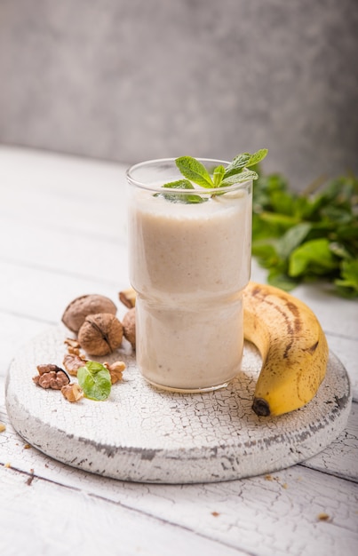 Healthy breakfast. Banana walnuts smoothie with collagen, coconut milk in glass jar