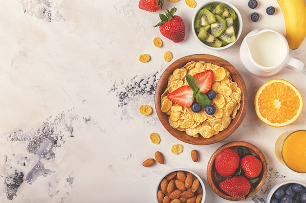 Healthy breakfast - bowl of corn flakes, berries and fruit