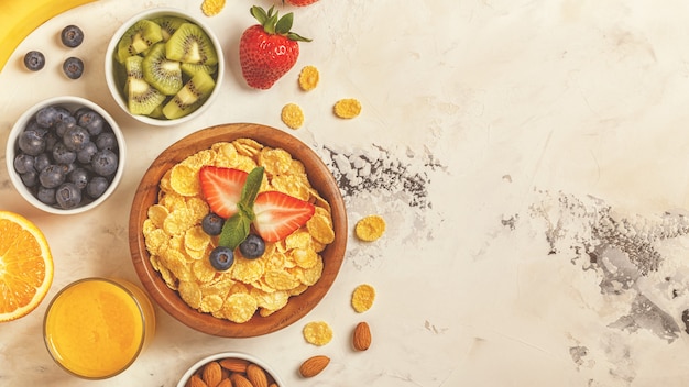 Healthy breakfast - bowl of corn flakes, berries and fruit