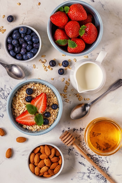 Healthy breakfast - a bowl of oatmeal, berries and fruit