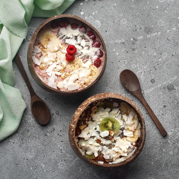 Healthy breakfast bowl oatmeal with banana kiwi almonds raspberries and chia seeds