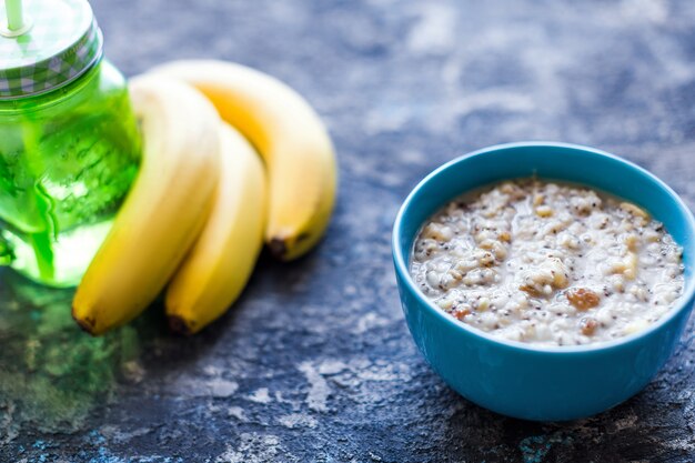 Healthy breakfast bowl. oatmeal with banana, raisins, walnuts, chia seeds