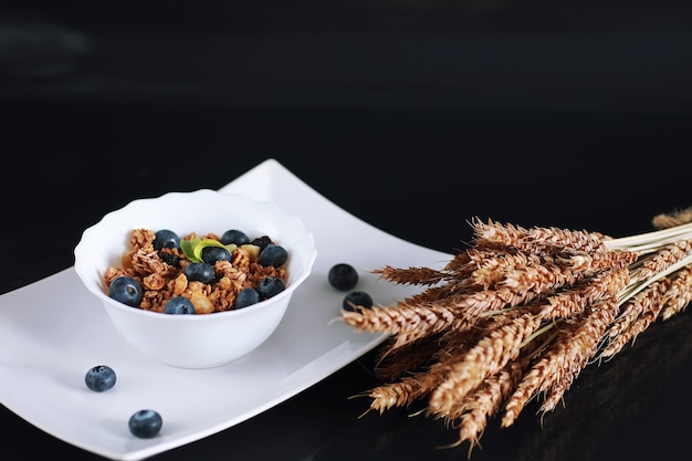 A healthy breakfast cereal with milk and fruit. Oat and corn flakes with chocolate and yogurt. The concept of healthy and vegetarian food.