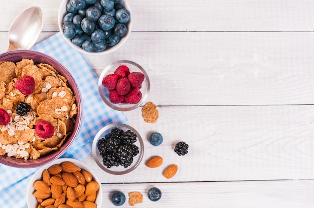 Healthy breakfast, coffee cornflakes berries and milk, with text space top view close-up