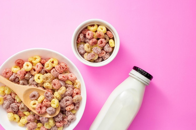 Healthy breakfast concept Colorful ring cereals in large bowl and mini bowl with milk in bottle