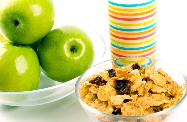 Healthy breakfast: cornflakes, glass of milk and green apples