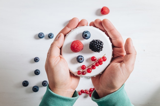 Healthy breakfast eating a mix of fresh raw berries fruits