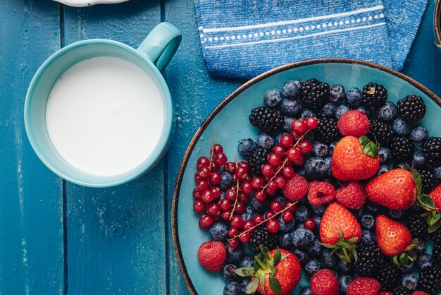 Healthy breakfast eating a mix of raw fresh berries fruits