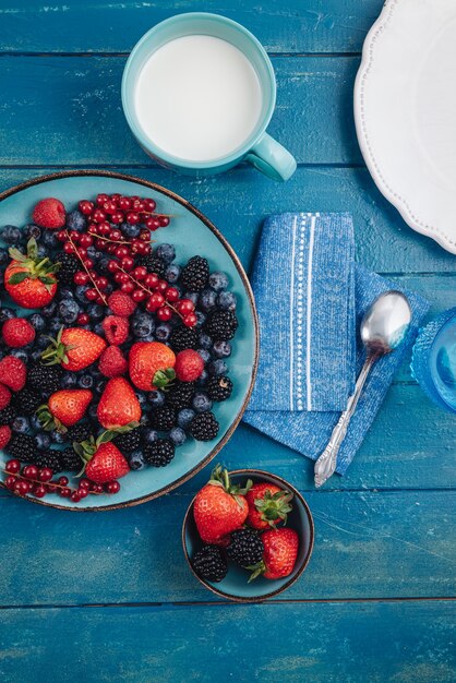 Healthy breakfast eating a mix of raw fresh berries fruits