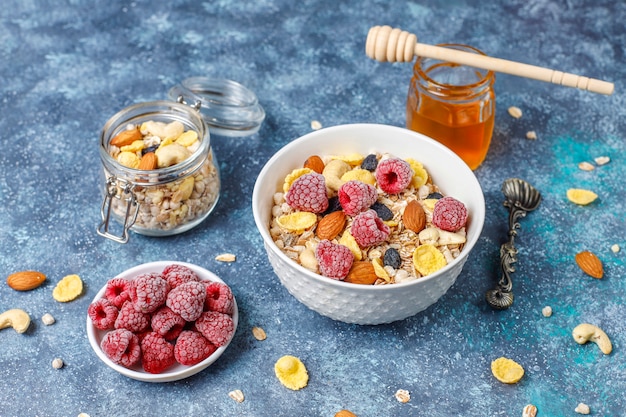 Healthy breakfast. Fresh granola, muesli with nuts and frozen berries. Top view. Copy space.