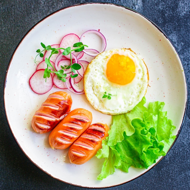 healthy breakfast, fried eggs sausages and vegetables