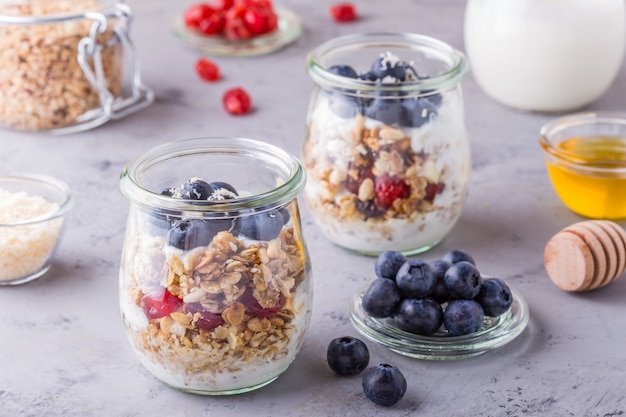 Healthy breakfast - glass jars of oat flakes with fresh fruit