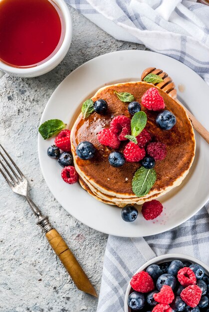 Healthy  breakfast,homemade classic american pancakes with fresh berry and honey