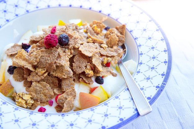 Healthy breakfast in the morning cereals berries and yoghurt