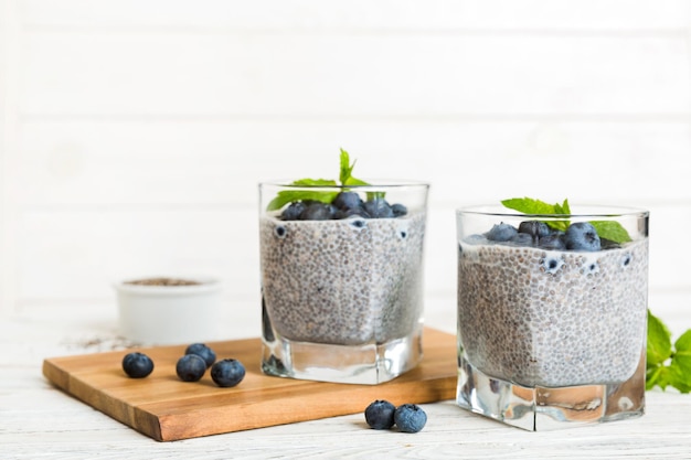 Healthy breakfast or morning with chia seeds vanilla pudding and blueberry berries on table background vegetarian food diet and health concept Chia pudding with coconut milk and blueberry