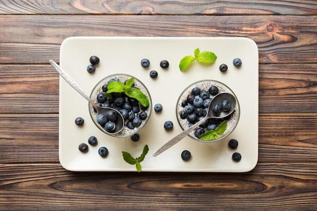 Healthy breakfast or morning with chia seeds vanilla pudding and blueberry berries on table background vegetarian food diet and health concept Chia pudding with coconut milk and blueberry