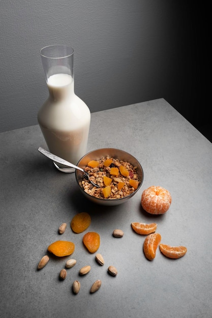 Healthy breakfast of muesli with fresh fruit and yogurt on a gray table