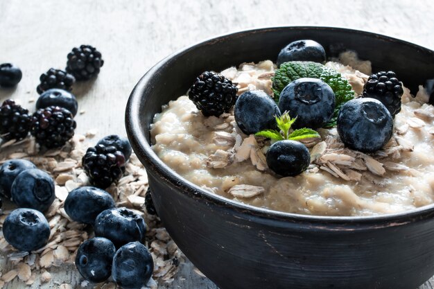Healthy breakfast. oatmeal porridge with ripe blueberries and blackberries