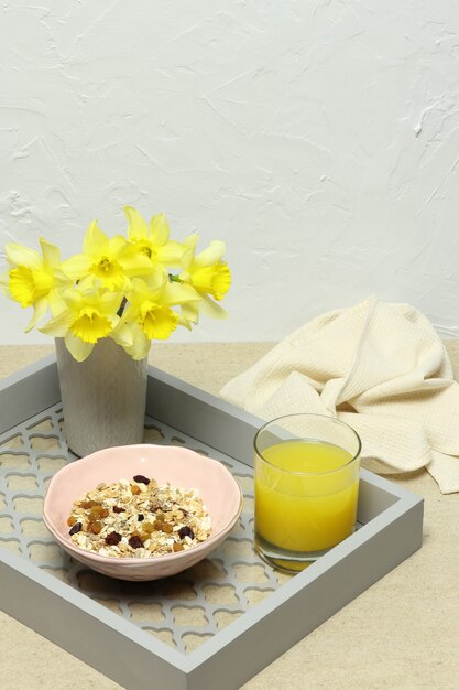 Healthy breakfast, porridge, orange juice, yellow flowers